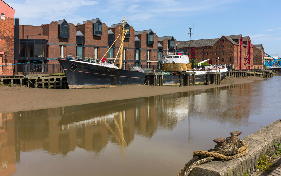 Obsolete ship beached on river bank, Hull, England, UK.